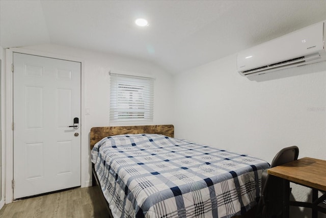 1010 Oakhill St, Seffner, FL 33584 - bedroom with a wall mounted AC, lofted ceiling, and light wood-type flooring