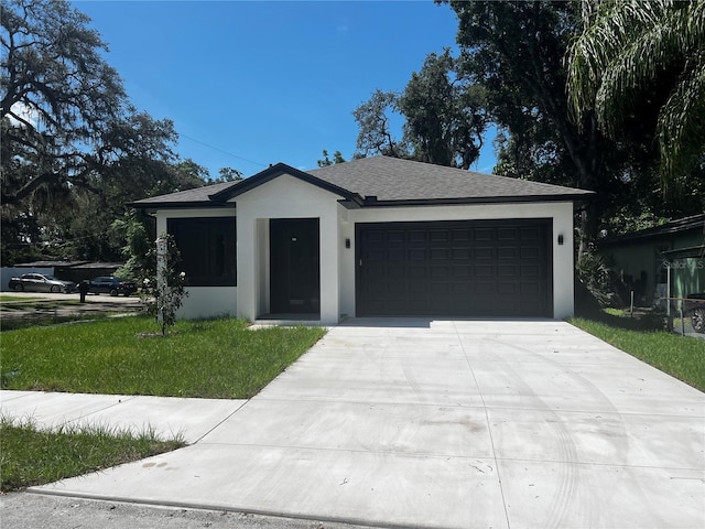 4241 E Palifox St, Tampa, FL 33610 - single story home featuring concrete driveway, an attached garage, a front lawn, and stucco siding