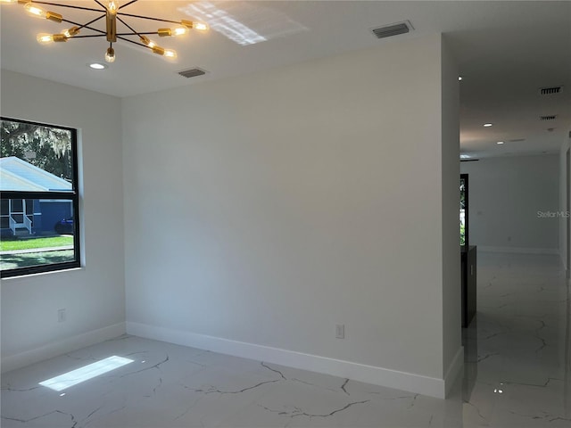 4241 E Palifox St, Tampa, FL 33610 - spare room featuring light marble finish flooring, a chandelier, and recessed lighting