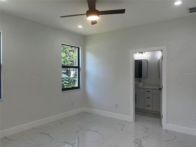 4241 E Palifox St, Tampa, FL 33610 - unfurnished bedroom featuring light marble finish floors, recessed lighting, ensuite bathroom, and a ceiling fan
