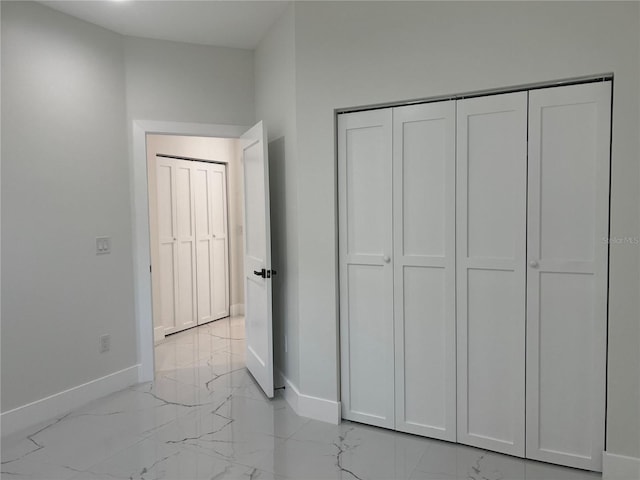 4241 E Palifox St, Tampa, FL 33610 - unfurnished bedroom with light marble finish flooring and a closet