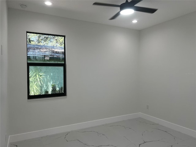 4241 E Palifox St, Tampa, FL 33610 - empty room with a smoke detector, recessed lighting, ceiling fan, and marble look tiles