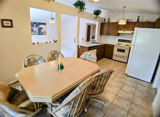 1262 Jeffords St, Clearwater, FL 33756 - kitchen with white appliances, under cabinet range hood, light countertops, a sink, and light tile patterned floors