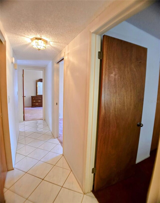 1262 Jeffords St, Clearwater, FL 33756 - corridor with a textured ceiling and light tile patterned floors