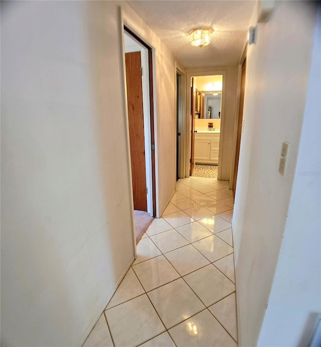 1262 Jeffords St, Clearwater, FL 33756 - hallway with light tile patterned floors and a textured ceiling