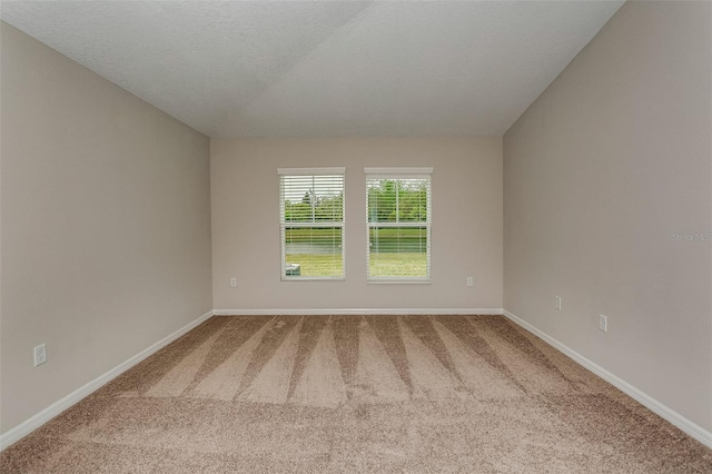 carpeted spare room with baseboards
