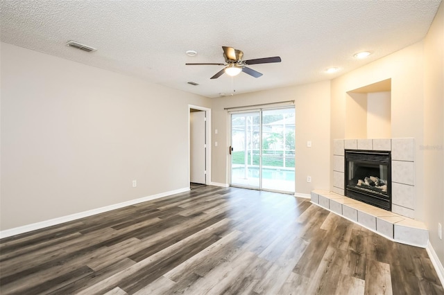 2216 Heathwood Cir, Orlando, FL 32828 - unfurnished living room featuring dark wood finished floors, a fireplace, ceiling fan, baseboards, and a textured ceiling