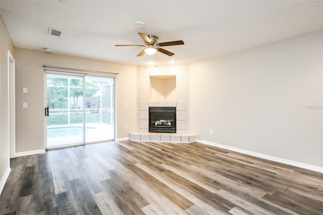 2216 Heathwood Cir, Orlando, FL 32828 - unfurnished living room featuring a ceiling fan, dark wood-style flooring, baseboards, and a fireplace