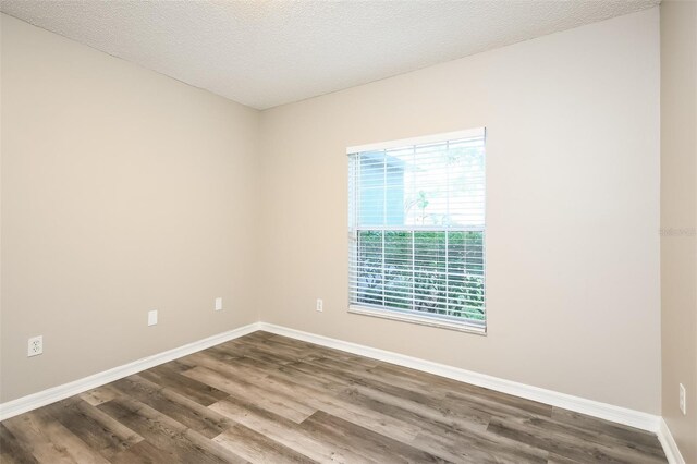 2216 Heathwood Cir, Orlando, FL 32828 - empty room with dark wood-style floors and baseboards