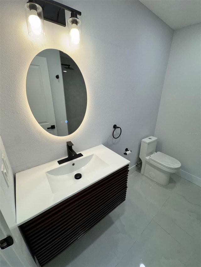 1778 New Hampshire Ave NE, Saint Petersburg, FL 33703 - bathroom with toilet, marble look tiles, vanity, and baseboards