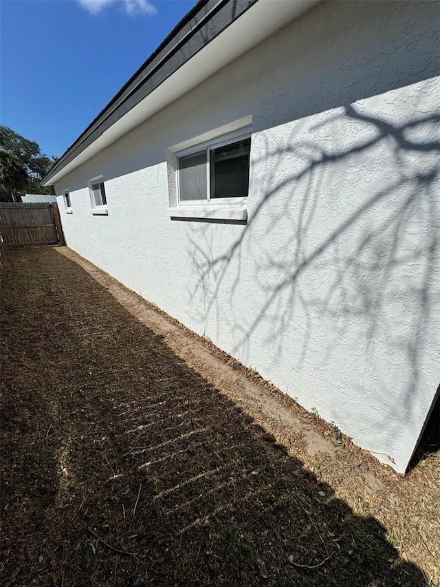 1778 New Hampshire Ave NE, Saint Petersburg, FL 33703 - view of side of home featuring stucco siding and fence