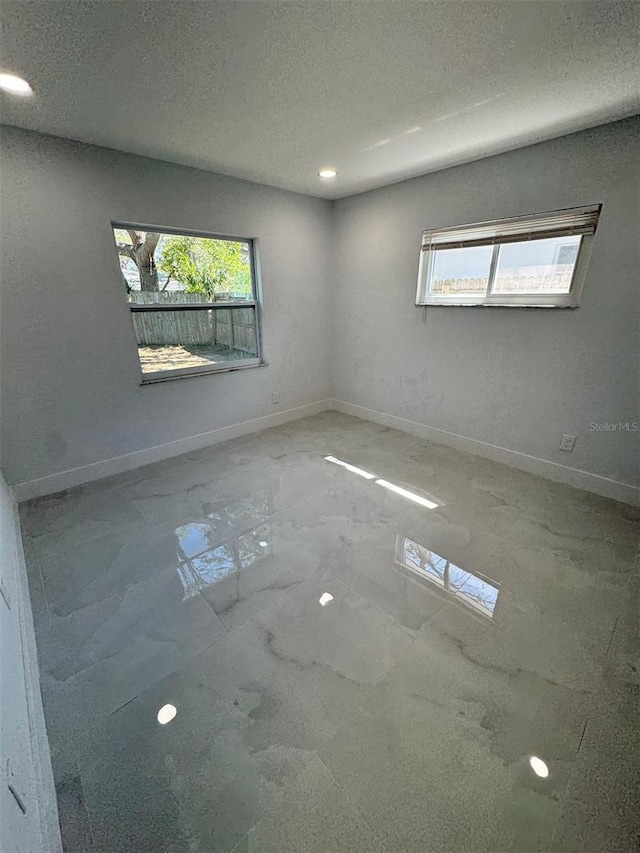 1778 New Hampshire Ave NE, Saint Petersburg, FL 33703 - spare room featuring healthy amount of natural light, baseboards, a textured ceiling, and recessed lighting