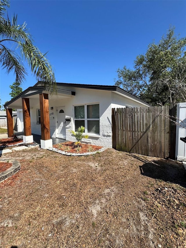 1778 New Hampshire Ave NE, Saint Petersburg, FL 33703 - view of property exterior with fence and stucco siding