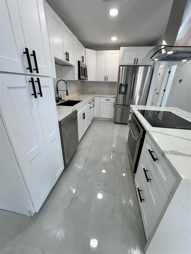 1778 New Hampshire Ave NE, Saint Petersburg, FL 33703 - kitchen featuring stainless steel appliances, a sink, island exhaust hood, light marble finish floors, and light stone counters