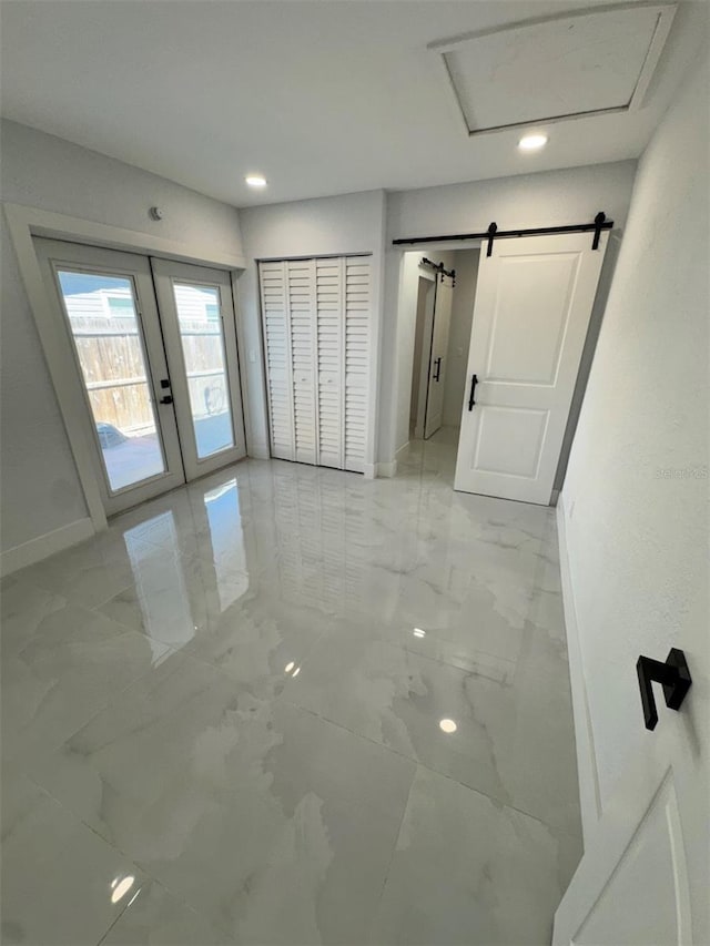 1778 New Hampshire Ave NE, Saint Petersburg, FL 33703 - unfurnished bedroom with light marble finish flooring, access to outside, a barn door, baseboards, and recessed lighting
