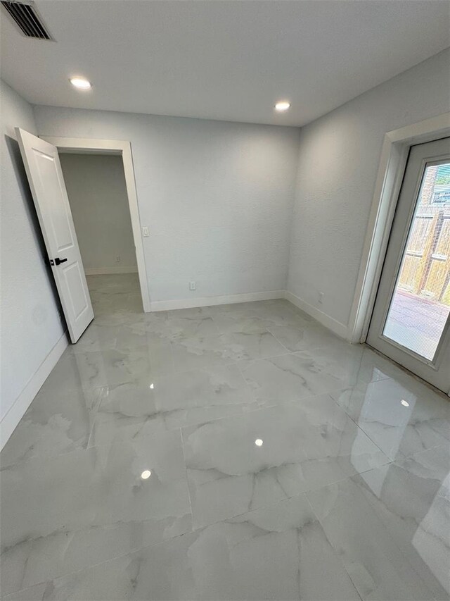 1778 New Hampshire Ave NE, Saint Petersburg, FL 33703 - empty room featuring baseboards, light marble finish floors, and recessed lighting