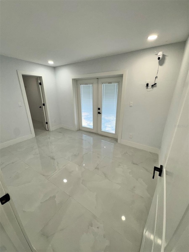 1778 New Hampshire Ave NE, Saint Petersburg, FL 33703 - unfurnished room with french doors, baseboards, light marble finish floors, and recessed lighting