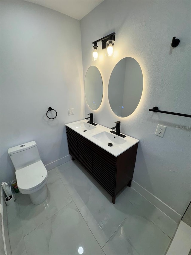 1778 New Hampshire Ave NE, Saint Petersburg, FL 33703 - full bathroom with marble finish flooring, toilet, baseboards, and double vanity