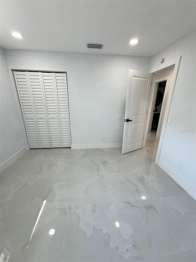 1778 New Hampshire Ave NE, Saint Petersburg, FL 33703 - unfurnished bedroom with light marble finish floors, baseboards, recessed lighting, and a closet