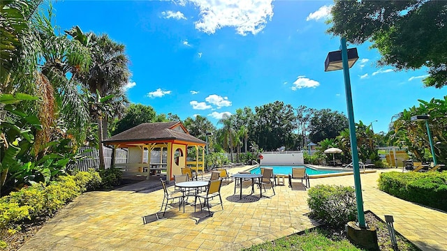 3907 Orchard Hill Cir, Palm Harbor, FL 34684 - view of community with a gazebo, fence, a swimming pool, and a patio area