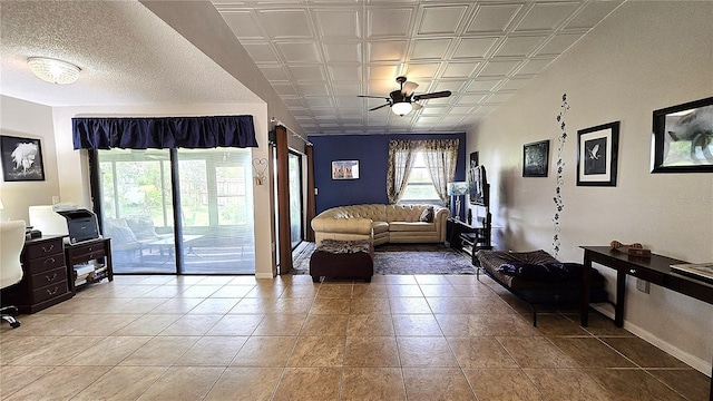 3907 Orchard Hill Cir, Palm Harbor, FL 34684 - tiled living room featuring ceiling fan and baseboards
