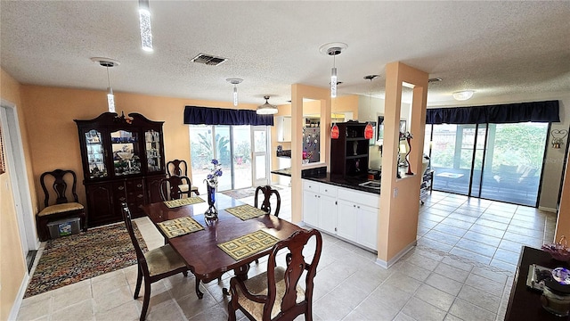 3907 Orchard Hill Cir, Palm Harbor, FL 34684 - dining space featuring a textured ceiling, healthy amount of natural light, and light tile patterned flooring