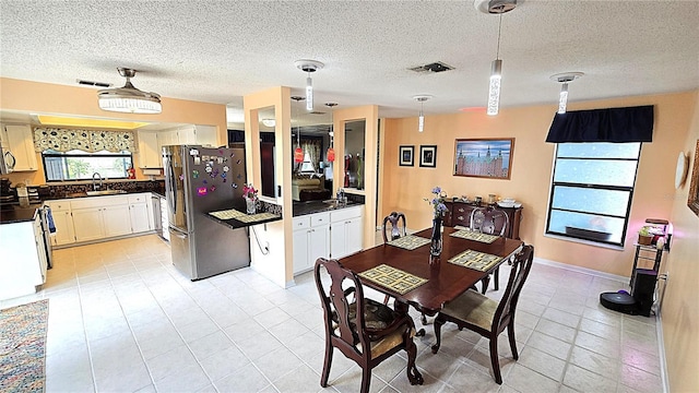 3907 Orchard Hill Cir, Palm Harbor, FL 34684 - dining space featuring light tile patterned floors and a textured ceiling