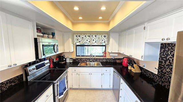 3907 Orchard Hill Cir, Palm Harbor, FL 34684 - kitchen featuring appliances with stainless steel finishes, a sink, dark countertops, white cabinets, and crown molding