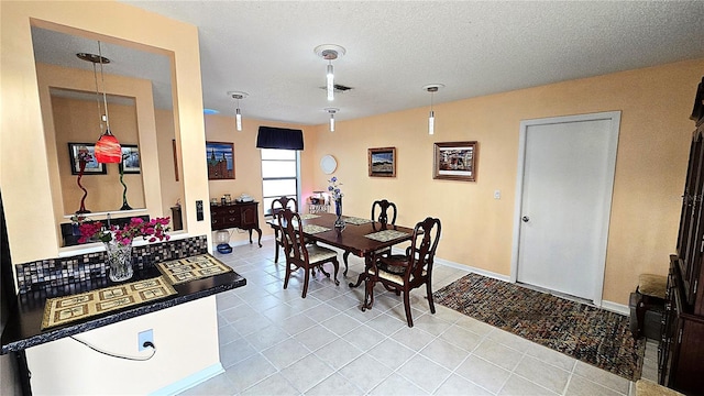 3907 Orchard Hill Cir, Palm Harbor, FL 34684 - dining space with light tile patterned floors, baseboards, and a textured ceiling