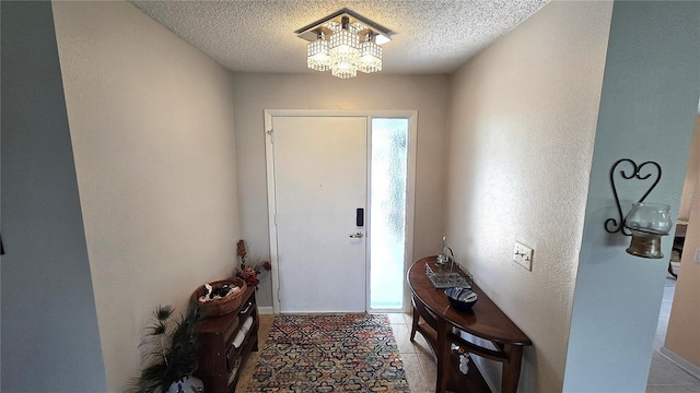 3907 Orchard Hill Cir, Palm Harbor, FL 34684 - entryway with a chandelier, a textured ceiling, and baseboards