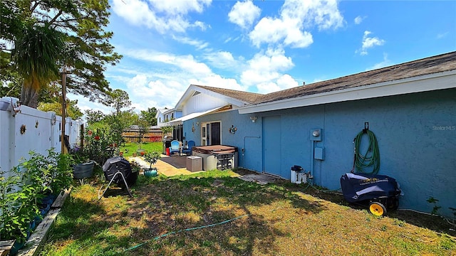 3907 Orchard Hill Cir, Palm Harbor, FL 34684 - view of side of property with a fenced backyard, stucco siding, and a patio area