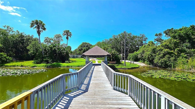 3907 Orchard Hill Cir, Palm Harbor, FL 34684 - dock featuring a gazebo, a water view, and view of scattered trees