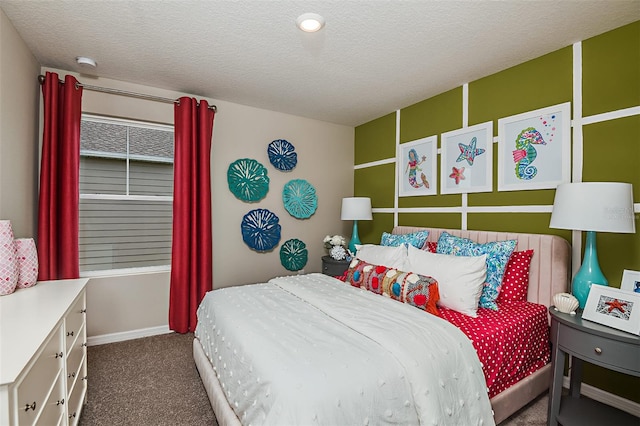carpeted bedroom featuring baseboards and a textured ceiling