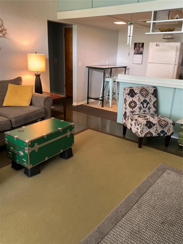 living room featuring carpet flooring and baseboards
