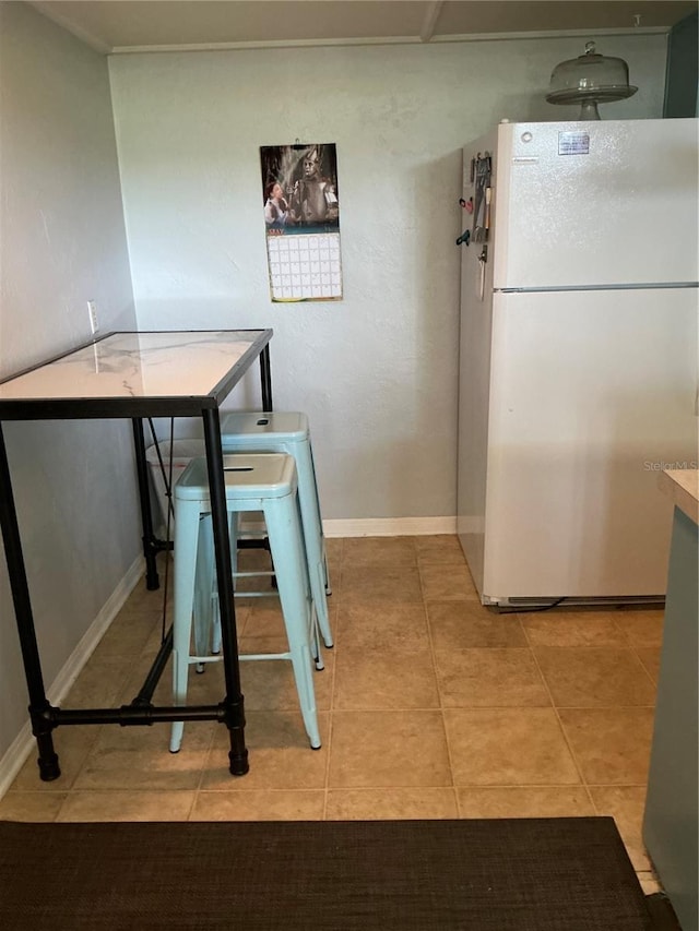 dining room featuring light tile patterned floors and baseboards