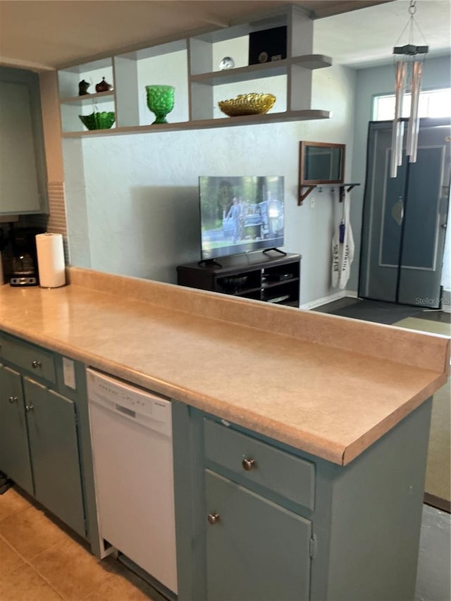 kitchen featuring white dishwasher, open shelves, gray cabinets, light tile patterned floors, and light countertops