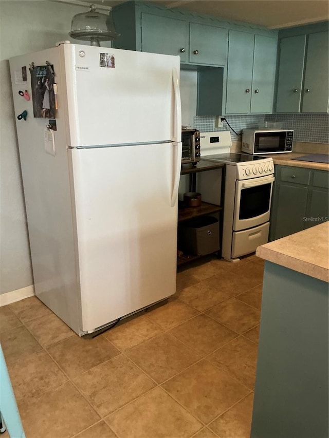 kitchen with white appliances, green cabinets, decorative backsplash, light tile patterned floors, and light countertops