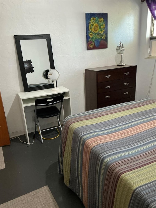 bedroom featuring concrete floors