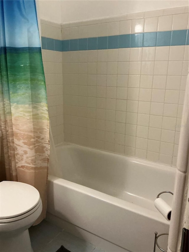 full bath featuring toilet, shower / tub combo, and tile patterned floors