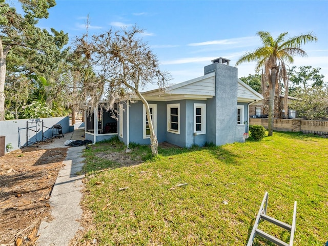 6726 Udell Ln, Hudson, FL 34667 - view of front facade featuring stucco siding and a chimney