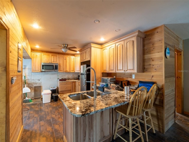 6726 Udell Ln, Hudson, FL 34667 - kitchen featuring stainless steel microwave, dark wood-style flooring, a peninsula, wooden walls, and light brown cabinets