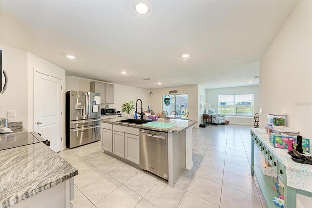 10732 Chippewa Dr, Parrish, FL 34219 - kitchen with appliances with stainless steel finishes, a sink, light tile patterned floors, recessed lighting, and a kitchen island with sink