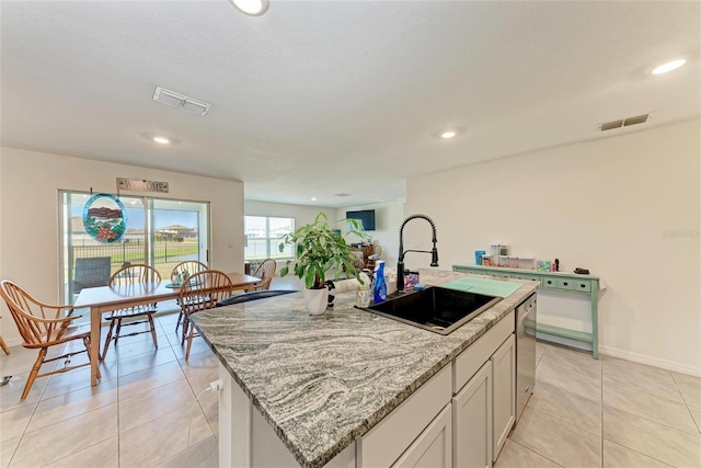 10732 Chippewa Dr, Parrish, FL 34219 - kitchen featuring a sink, a kitchen island with sink, light tile patterned floors, recessed lighting, and light stone countertops
