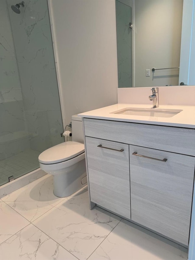 full bath with marble finish floors, a marble finish shower, toilet, and vanity