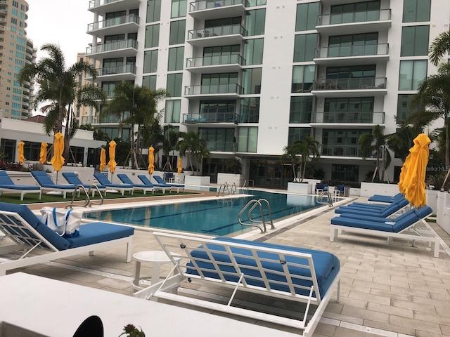 community pool with a patio area