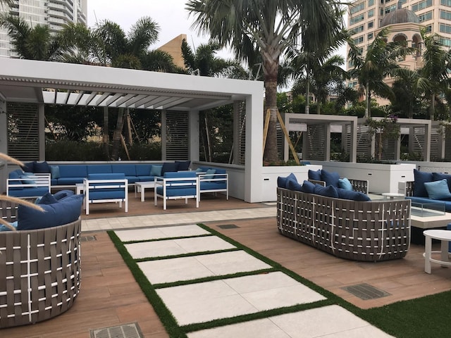 wooden terrace with outdoor lounge area and a patio