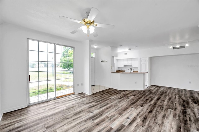 9602 Lake Chase Island Way Unit 9602, Tampa, FL 33626 - unfurnished living room with wood finished floors, ceiling fan, and baseboards