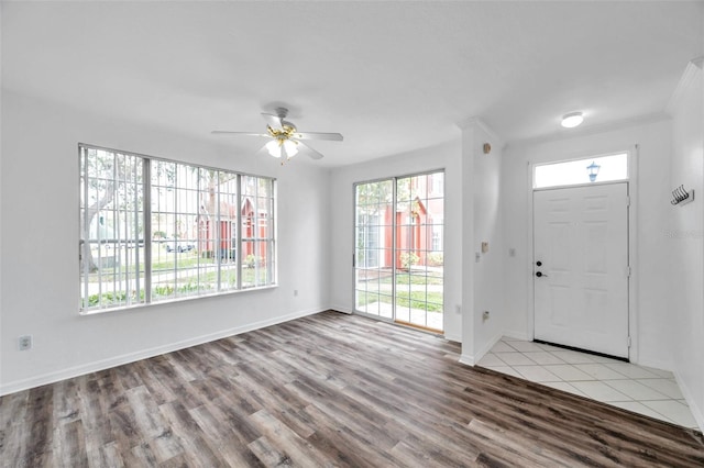 9602 Lake Chase Island Way Unit 9602, Tampa, FL 33626 - foyer entrance featuring healthy amount of natural light, wood finished floors, a ceiling fan, and baseboards