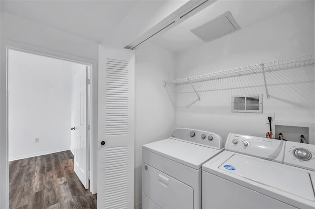 9602 Lake Chase Island Way Unit 9602, Tampa, FL 33626 - laundry area featuring washer and dryer, dark wood-type flooring, and baseboards