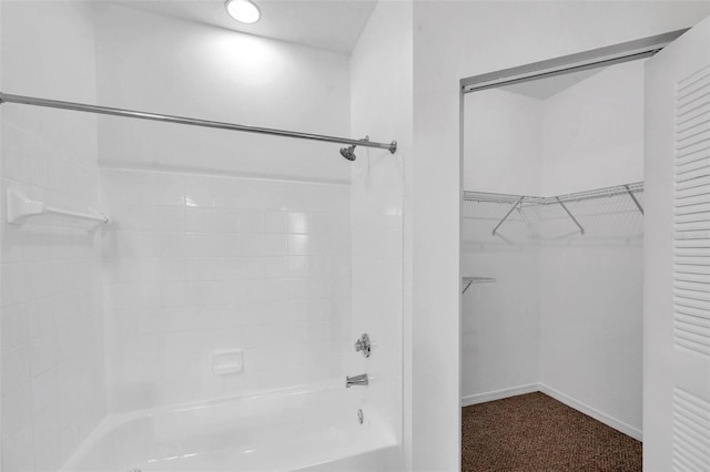 9602 Lake Chase Island Way Unit 9602, Tampa, FL 33626 - bathroom featuring bathtub / shower combination, baseboards, and a spacious closet